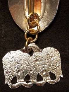 A decrative pewter piece that spreads out Bead strands between 2 brooches . The shape is a S.C.A. Pelican Shape the short Chain is 4 links. Made of 3/32 Yellow Bronze. they are sold by the pair and will show as the Picture does . The Brooches are Sold Seperatly . the castings are thicker on the hole ends to make them more Durable. When you purchase this item you get 2 of the Hangers/ Spreaders . and these ones are Mirrored . Unique Metal Jewelry Brooch, Unique Silver Metal Brooches, Unique Silver Metal Brooch, Handmade Silver Costume Jewelry Brooches, Unique Metal Brooch, Collectible Silver Metal Brooches, Bead Strand, Spreads, Hangers