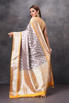 Stunning grey Katan silk sari with yellow zari border and pallu. It comes with a matching blouse piece. Shop designer sarees in USA from Pure Elegance. Disclaimer: The shown stitched blouse on the model is for display purpose only. The saree comes with a matching blouse piece and finished with fall and piko. Designer Cotton Silk Pre-draped Saree With Border, Bollywood Style Gray Semi-stitched Traditional Wear, Gray Traditional Wear For Festive Occasions, Gray Festive Traditional Wear, Festive Gray Traditional Wear, Semi-stitched Gray Traditional Wear With Zari Work, Gray Traditional Wear With Pallu, Traditional Gray Wear With Pallu, Gray Traditional Wear For Diwali