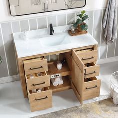 a bathroom vanity with drawers and a sink in the middle, next to a mirror