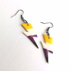 Handmade from polymer clay in Cardiff, UK. Set contains; One pair of drop earrings in a PRIDE flag themed design. Approx 3.5cm Hypoallergenic stainless steel hooks Don't forget, 10% of profits from the sale of PRIDE COLLECTION items goes to our nominated LGBTQ+ charity. **Colours may vary slightly from image due to resolution differences. Colour patterns may not match photographed item but will be cut from same piece/collection. Shapes and sizes may also vary due to the nature of handmade products. Pride Collection, Gothic Clothing, Non Binary, Pride Flag, Gothic Outfits, Lightning Bolt, Pride Flags, Handmade Products, Color Patterns