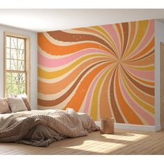 a bedroom with an orange and pink wall mural