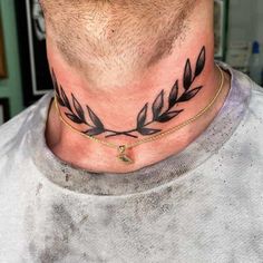 a man with a tattoo on his neck is wearing a gold chain and has an olive branch