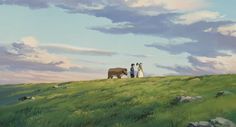 two people standing on top of a lush green field next to an elephant in the distance