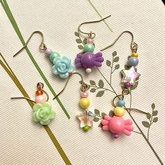 These colorful and whimsical earrings from Saltair Bead Studio are a great way to add some playfulness to your wardrobe.  A standard size gold earring hook. The beaded drop measures 1 inch and features a mix of glass and acrylic beads in a range of pastel colors. All metal is lead and nickel free. Choose matching styles or mix them up! I want you to be 100% happy with your purchase and pride myself in great customer service! Please reach out if you have any questions or concerns. Want to see what new creations will soon be arriving in Saltair Bead Studio? Follow me on tiktok or instagram @SaltairBeadStudio. Trendy Dangle Flower Earrings With Ear Wire, Trendy Dangle Flower Earrings, Playful Single Dangle Earring, Whimsical Beaded Earrings With Dangling Beads For Gifts, Whimsical Beaded Earrings As A Gift, Fun Dangling Beads Jewelry For Gifts, Fun Dangling Beads Jewelry As Gift, Fun Dangle Beaded Earrings With Ear Wire, Fun Jewelry With Dangling Beads For Gift