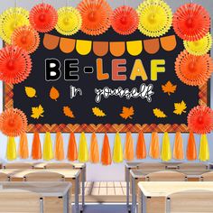 a classroom decorated with orange and yellow paper flowers, pom poms, and tassels