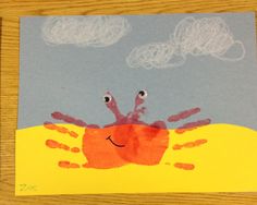 a child's drawing of a crab on a yellow and blue background with clouds