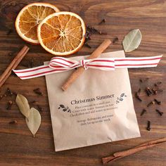 an orange slice and cinnamon stick tied to a paper bag with the message christmas slimmer on it