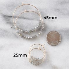 Think of these semi precious beaded hoop earrings as Libby & Smee Deluxe! Quite simply, these'll be the hoops that you'll want to wear every single day. Plus the gemstones all offer a little woo-woo — if that's your thing! 45mm (about 1.75") or 25mm (about the size of a quarter) gold-filled hoops with gemstone beads packaged on a kraft earring card in a clear resealing bag gold-filled hoops are lead-free gold over brass. Gold-filled has much more gold than gold-plated and will last longer withou Woo Woo, Gemstone Hoop Earrings, Earring Card, Gold Filled Hoops, Earring Cards, Beaded Hoop Earrings, Brass Gold, Pink Tourmaline, Tiger Eye