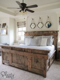 a bedroom with a bed and ceiling fan on the wall above it is featured in an instagram