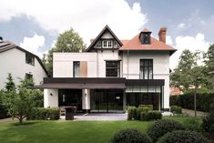 a large white house sitting on top of a lush green field