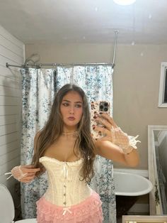 a woman in a corset taking a selfie