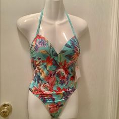 Kikirio Swimsuit Size S Floral Patterns Beautiful Colors Size Small New With Tags Built-In Bra Hook In The Back Sexy And Feminine. The Suit Is 85% Nylon 15% Spandex Which Will Give You A Very Good Stretch $44 Tag On That They Have The Color Of Seafoam Green.This Would Be An Eyecatcher On The Beach Or Out At The Pool Word On A Cruise On Your Boat. Loc Box 200 + 10 0r 500 Tropical Spring Bodysuit For Poolside, Tropical Spring Bodysuit For Pool, Tropical Spring Pool Bodysuit, Spring Tropical One-piece Bodysuit, Blue Tropical Bodysuit For Beach Season, Blue Tropical Bodysuit For The Beach, Spring Beach Bodysuit With Triangle Top, Blue Tropical Bodysuit For Beach, Multicolor Spring Vacation Bodysuit