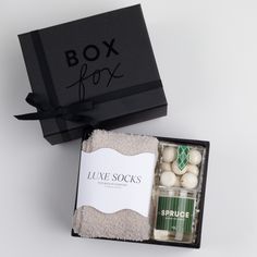 BLACK BOXFOX box displayed open with grey socks, peppermint crunch candy and a candle labeled in the scent SPRUCE. Christmas Gift Coworkers, Peppermint Bark Bites, Luxury Spa Gift Set, Holiday Skincare Gift Set, Box Fox, Peppermint Bark, Corporate Gifts, Peppermint, Matte Black