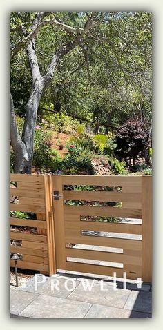 a wooden fence in front of a tree