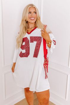 - Activate game day mode with this trendy mini dress! It's effortlessly stylish sequined design adds the perfect amount of sparkle. Bring glam to the game with this adorable dress. Get the Game Day essentials for the Alabama Crimson Tide, Arkansas Razorbacks, Arkansas State Red Wolves, Texas A&M Aggies, Texas Tech Red Raiders, University of Georgia Bulldogs, University of Oklahoma Sooners, or the University of Louisville Cardinals teams. - Sleek, stretchy faux leather material - A v-cut neckline White V-neck Sequin Dress, Fall White Sequin Dress, White Sequin Dress For Fall, White Sequin Dresses For Fall, White Mini Dress With Contrast Sequin For Night Out, White Contrast Sequin Mini Dress, White Mini Length Sequin Dress, White V-neck Mini Dress For Party Season, White Long Sleeve Sequin Dress For Party Season