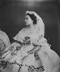 an old black and white photo of a woman in a wedding dress