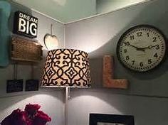 a lamp that is sitting on top of a table next to a clock and other items