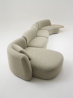 the curved couch is made from fabric and wood