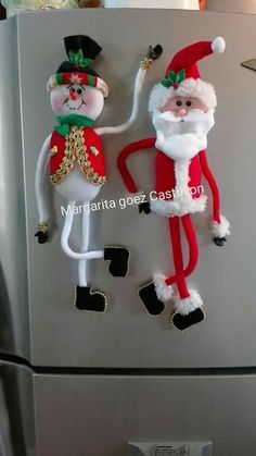 two christmas decorations on the side of a refrigerator