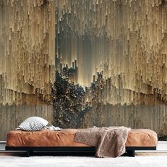 a bed sitting in front of a wall covered in wood planks and bamboo sticks