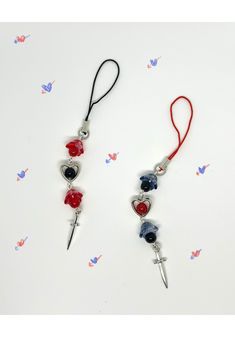 two red, white and blue beaded necklaces with scissors hanging from the side