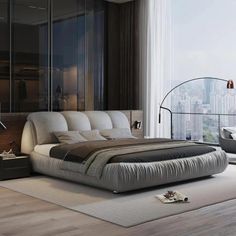 a large bed sitting in the middle of a bedroom next to a tall glass window