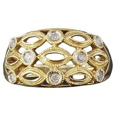 a gold and diamond ring on a white background with an oval design in the middle