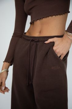 Elevate your comfort game with our Bodhi Sweatpants. Made with a drawstring waist for the perfect fit, experience optimal relaxation in these cozy sweatpants. Perfect for lounging at home or a casual day out. Upgrade your wardrobe with this must-have piece. Drawstring waist sweatpant with two front and one back pocket 100% Cotton Machine wash cold, tumble dry on low heat Model A: Paige is wearing a size XS Model A Measurements: Height: 5'8, Bust: 32B, Waist: 24", Hips: 34" Model B: Anyssa is wea Sporty Brown Pants For Fall, Relaxed Drawstring Pants For Loungewear, Brown Sporty Sweatpants For Fall, Comfy Sweatpants For Relaxation In Fall, Relaxed Fit Drawstring Bottoms For Relaxation, Sporty Brown Sweatpants For Fall, Athleisure Bottoms With Drawstring For Relaxation, Brown Lounge Pants With Ribbed Waistband, Brown Loungewear Pants With Ribbed Waistband