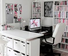 a home office with lots of bookshelves and white furniture