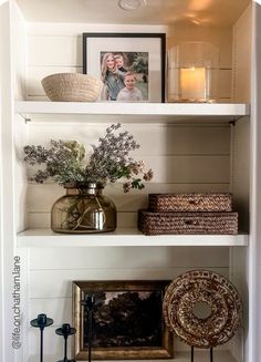 the shelves are filled with vases, pictures and other decorative items on top of them