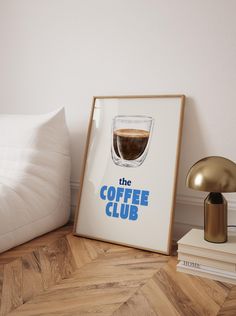 the coffee club poster is next to a lamp