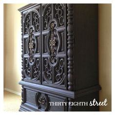 an ornate black cabinet is shown against the wall