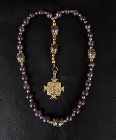 "The Anglican Rosary called \"the Spiritual Path\" is a unique and very beautiful rosary that is based on the heavenly colors which will radiate a calming effect while praying. The rosary is made of high quality Hematite, Amethyst and Dragon Blood gemstones (which have been cleansed and purified) while a Stainless Gold Brass Cross medal completes the rosary. Finally, the rosary has been blessed by the church. Rosary: Anglican configuration Blessed: Yes About the Rosary: The Rosary has a Cross, a Anglican Rosary, Cross Medal, Dragon Blood, Praying The Rosary, The Rosary, Energy Bracelets, Spiritual Path, Dragons Blood, Hematite Beads