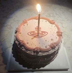 a birthday cake with a lit candle on it