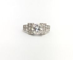 an antique style diamond ring on a white background