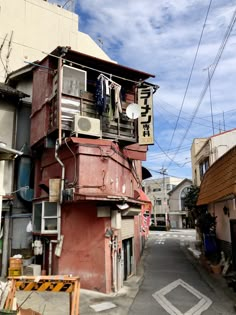 a red building with clothes hanging from it's balconies