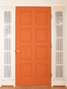 an orange front door with two white doors