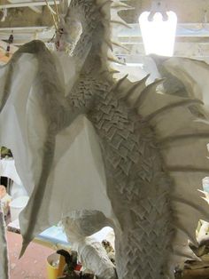 a white dragon statue sitting on top of a table