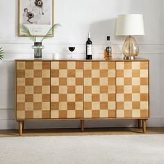 a large wooden cabinet sitting next to a lamp on top of a rug in a living room