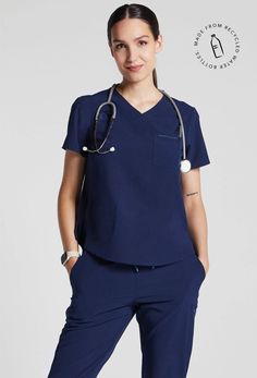 MADE FOR THE WAY YOU MOVE™: A classic short sleeve scrub top you will wear over and over again, in buttery-soft lightweight, stretchy fabric. The flattering shirt tail hem with a classic fit and room for layering when you want a bit more coverage. A badge tab, well-placed functional pockets, reflective branding for safety and a water-repellent treatment to get you through your shift. These scrubs are breathable, wash up like new and customers rave over the flattering fit. Bonus: They are made wi Slim Suit Pants, Mens Workout Pants, Wrap Tunic, Womens Golf Shirts, Women's Uniforms, Slim Suit, Cropped Linen Pants, Medical Scrubs, Round Neck Tees