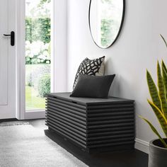 a black bench sitting in front of a white door