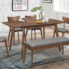 a dining room table with four chairs and a bench