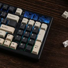 a computer keyboard sitting on top of a wooden table