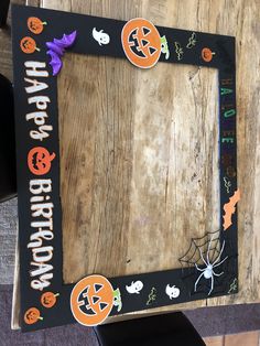 a wooden frame decorated with halloween decorations