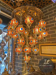 a chandelier hanging from the ceiling in a room with many lights on it