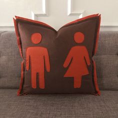 a brown and orange pillow with two people on it