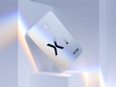 a white credit card sitting on top of a pedestal