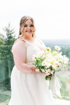 a woman in a wedding dress holding a bouquet