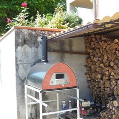 a large pile of wood sitting next to a building