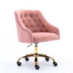 a pink velvet office chair with gold wheels and casteors on an isolated white background